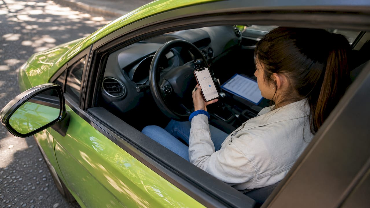 Learner driver checking lesson schedule on phone