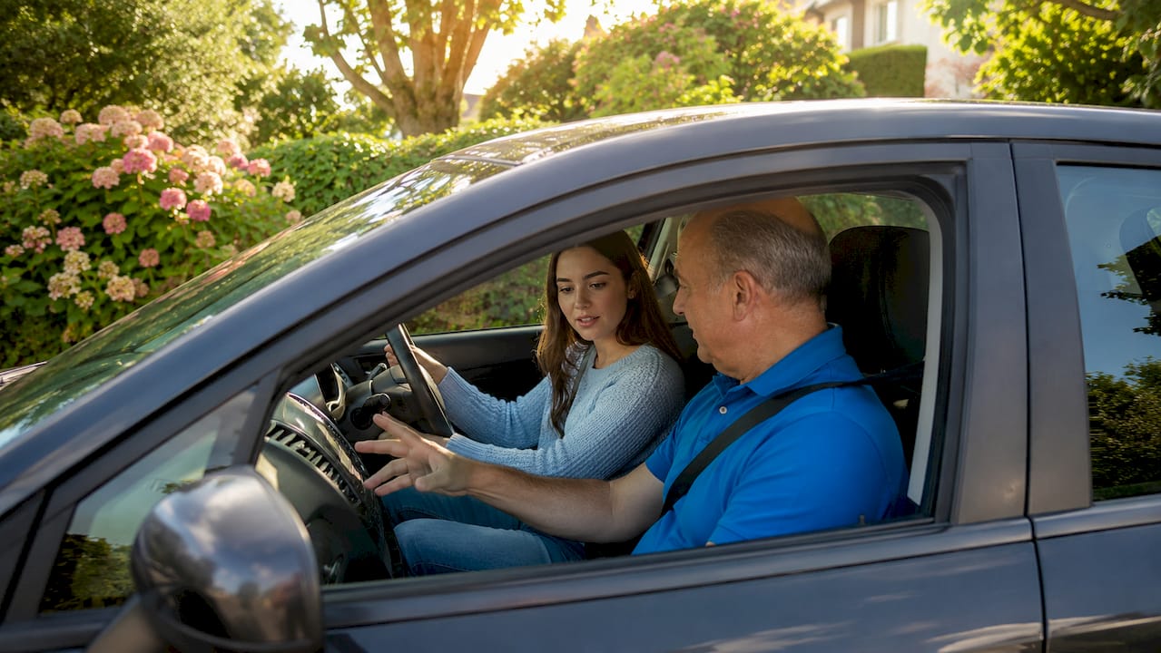 Learner driver receiving instruction from instructor in car